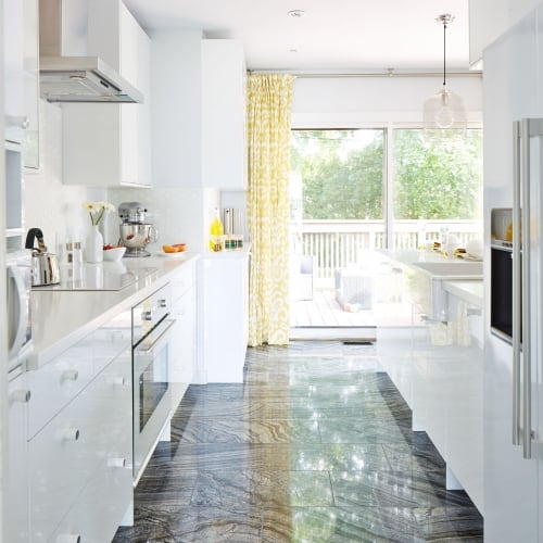 View of galley kitchen showcasing marbled tile